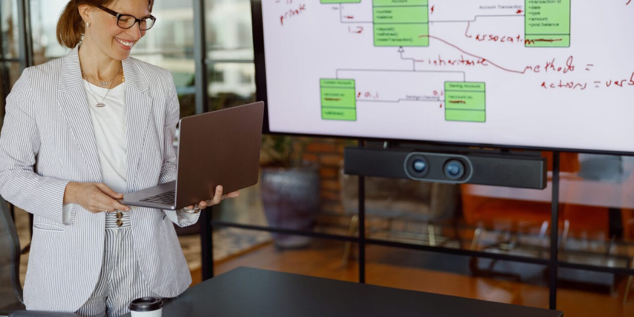 An experienced professional woman skillfully presenting a digital chart within a contemporary office setting
