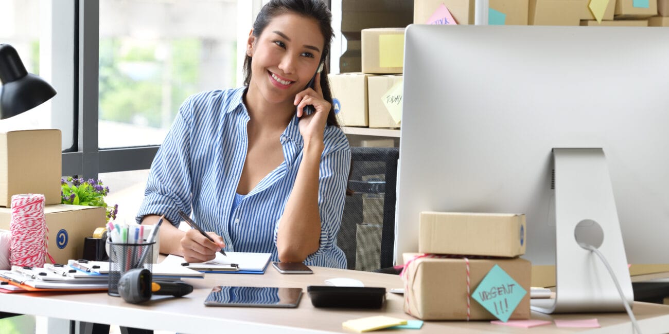 Young Asian woman entrepreneur/ Business owner working with computer at home