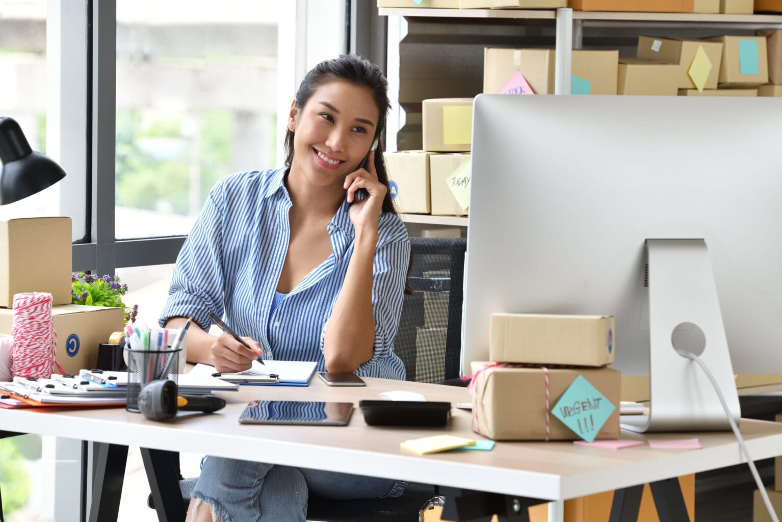 Young Asian woman entrepreneur/ Business owner working with computer at home